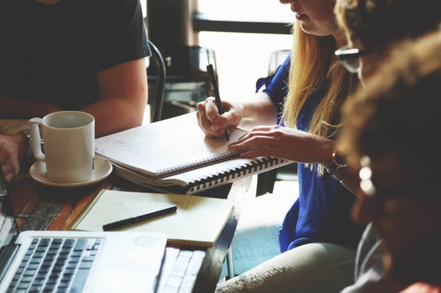 group of students in a table trying to write resume for internship