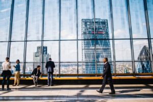 man walking beside big building looking for writers of executive resumes