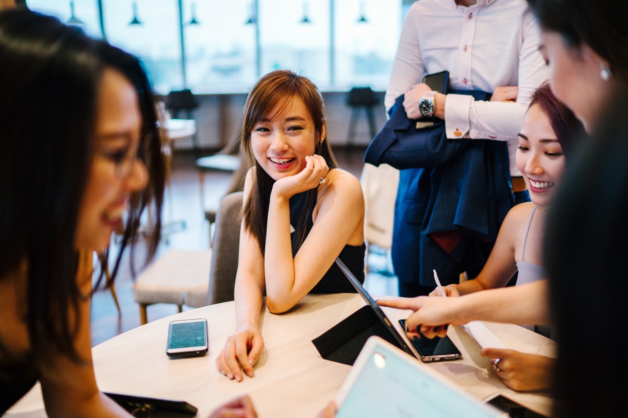 group of students around a table trying to write resume for internship