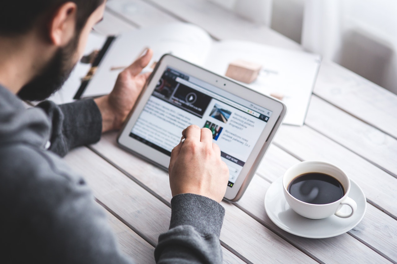 man researching for job interview strategies in a tablet