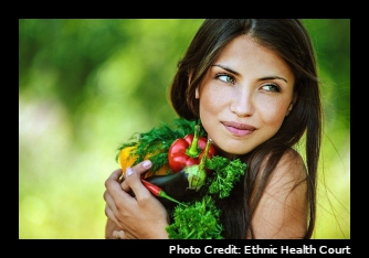 A woman holding vegetables close to her