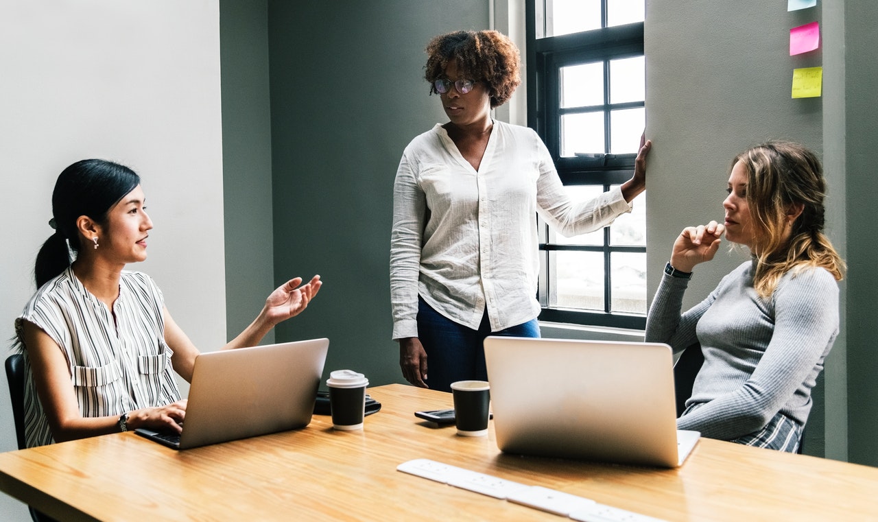 three-women-talking-inside-a-room-to-resolve-office-drama