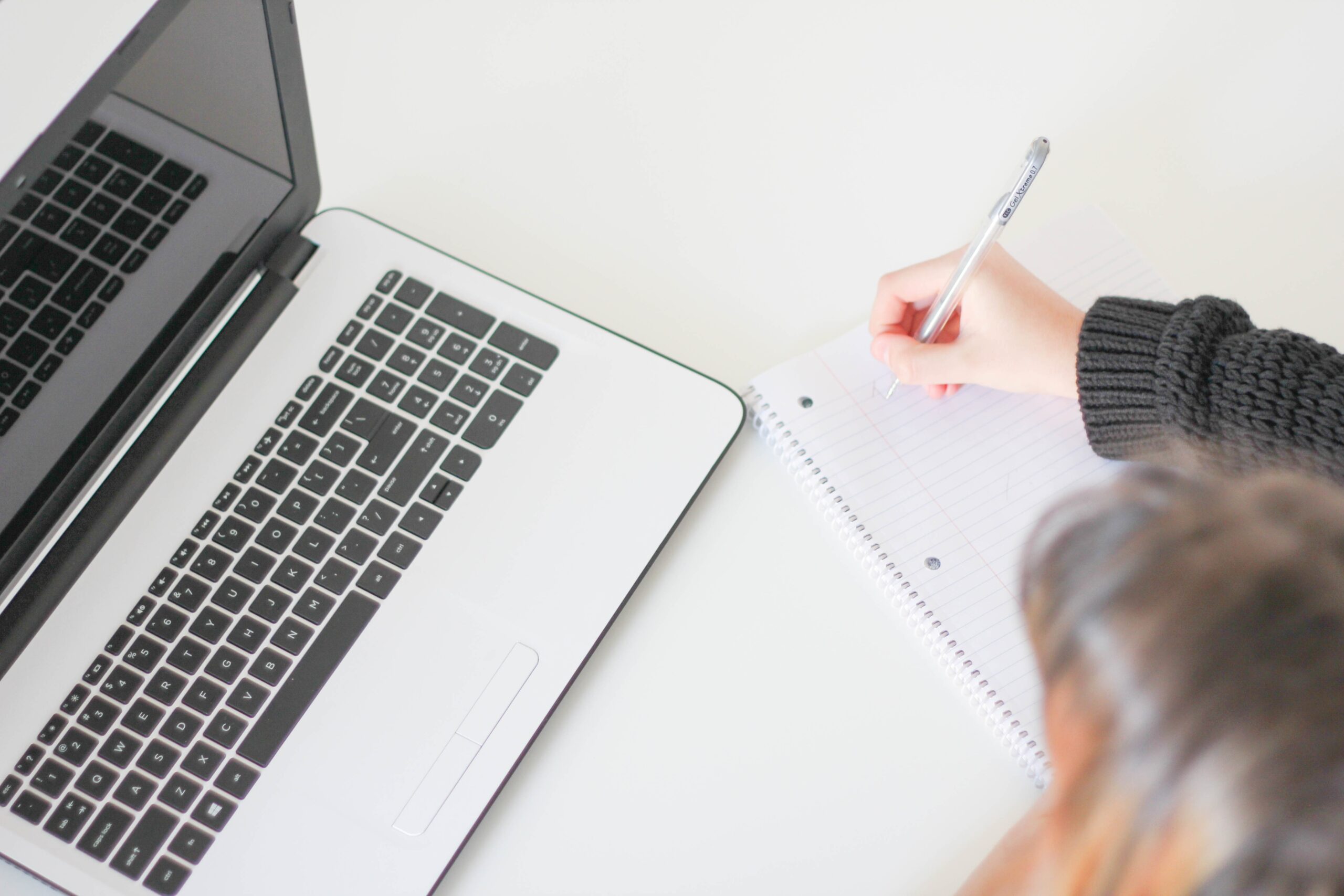 a laptop and a notebook on top of the table