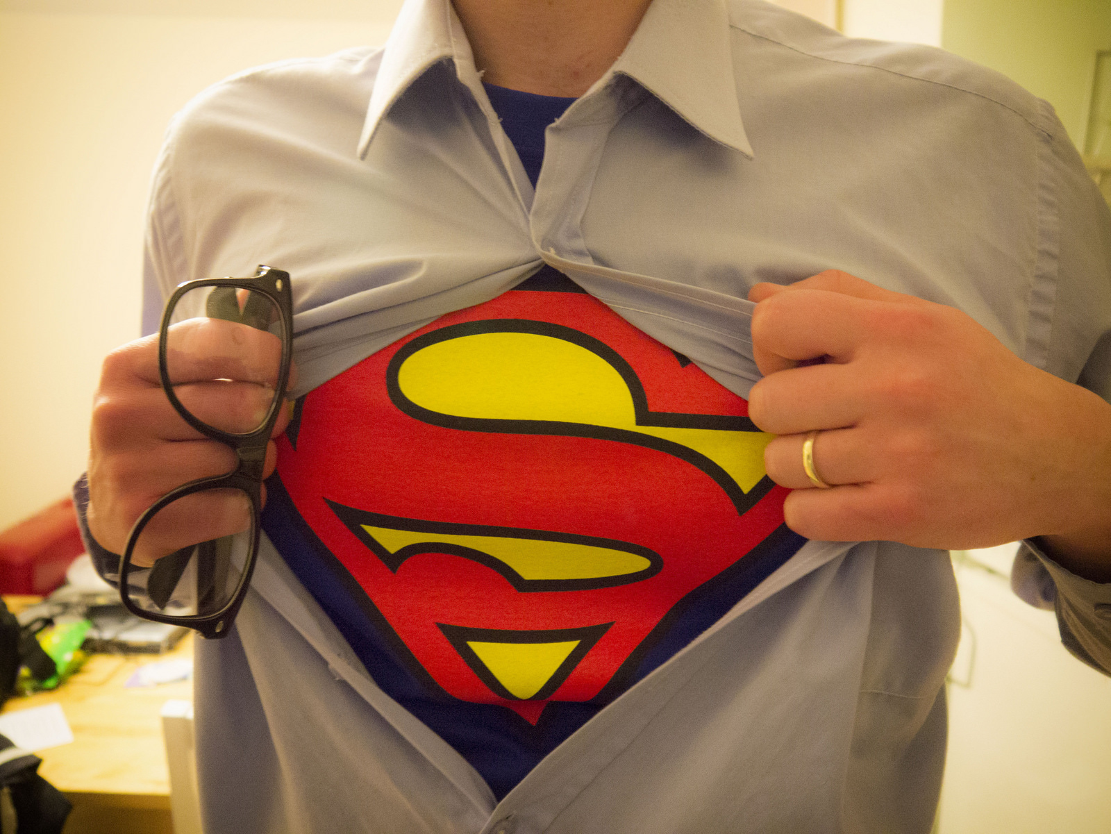 Man revealing his Superman undershirt