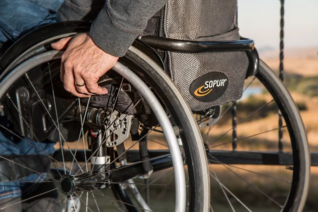 Person with disability sitting on a wheelchair