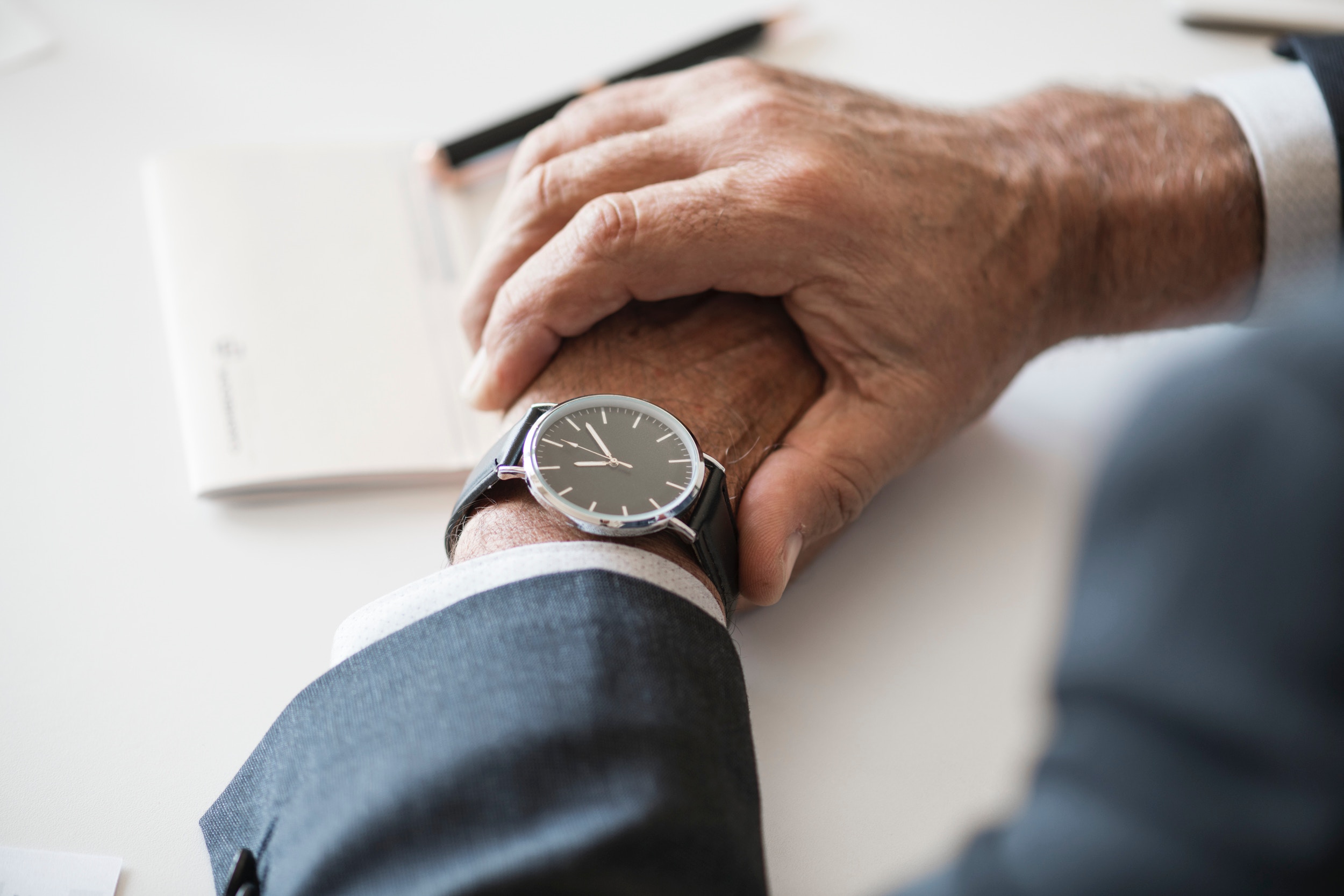 a man wearing a wrist watch during an executive job interview