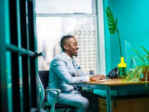 Man in suit writing his executive cv