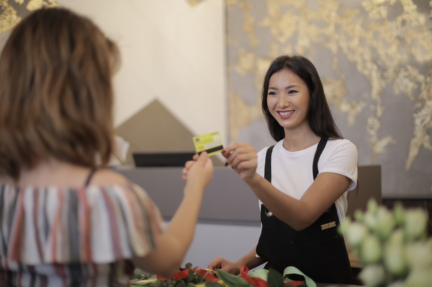 A cashier doing her job while embodying every cashier job description