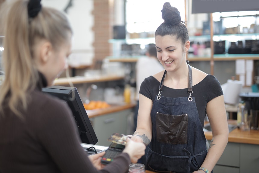 A cashier working now after placing cashier job description on her resume