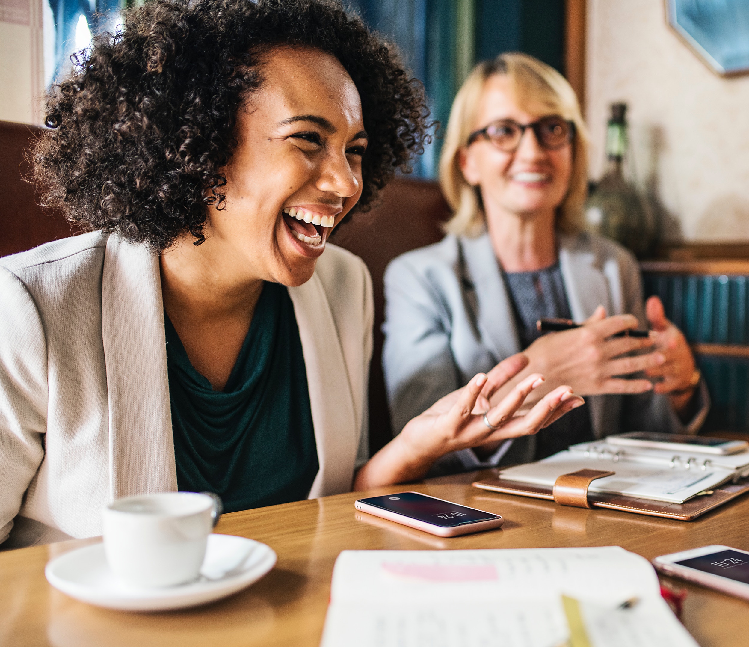 a happy vibe in an office, a girl is smiling because of a job promotion