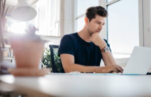 a job seeker uses his laptop to include resume skills examples he saw online on his resume