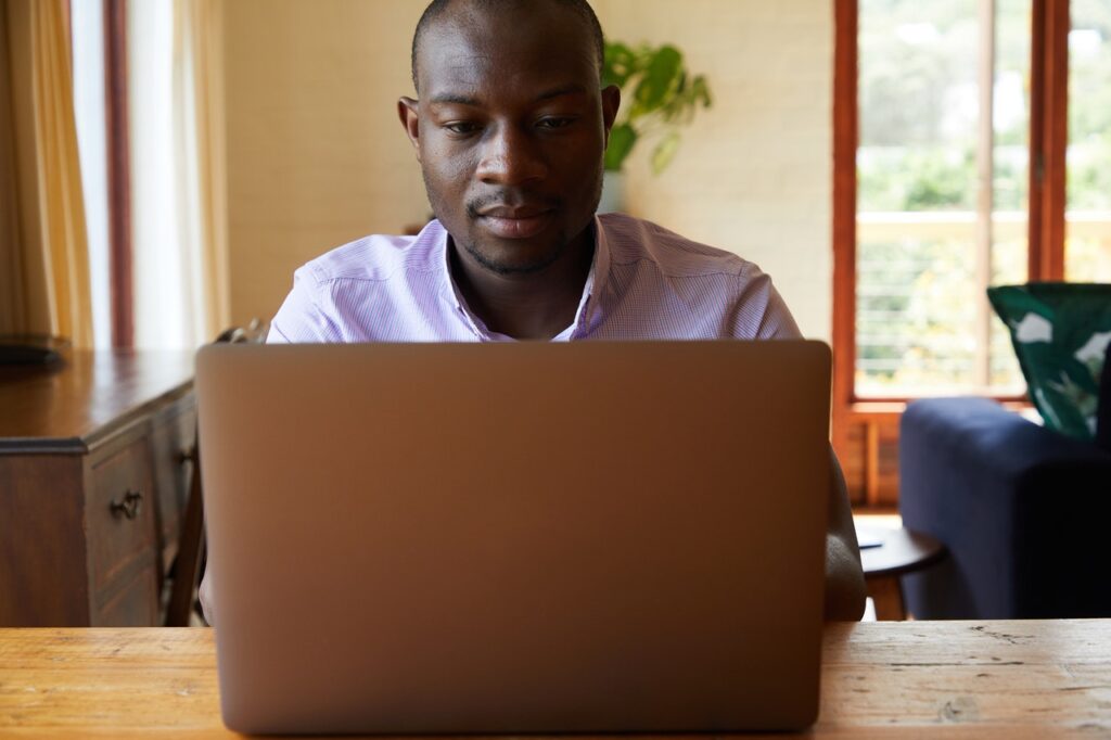 man reviewing his skills for resume on his laptop