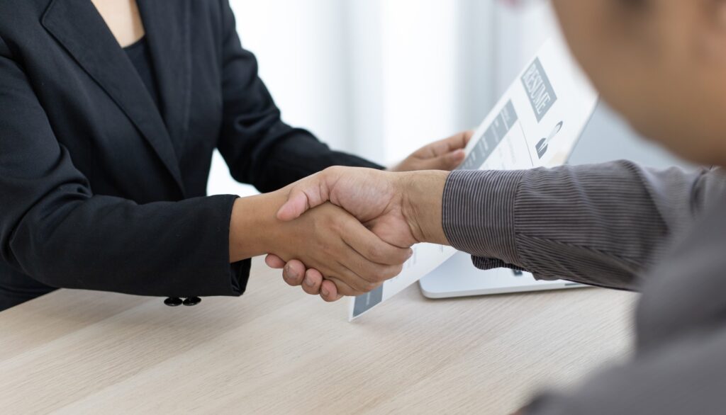 employer or HR department welcomes new employees shaking hands