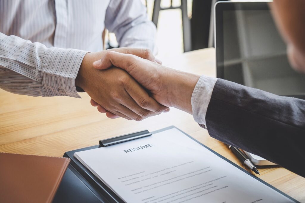 recruiter and applicant shaking hands to signify job search success